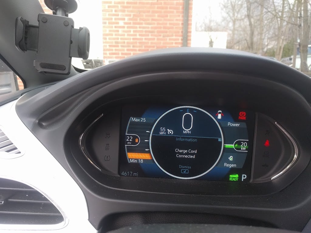 Vehicle dashboard showing a charge cord connected message