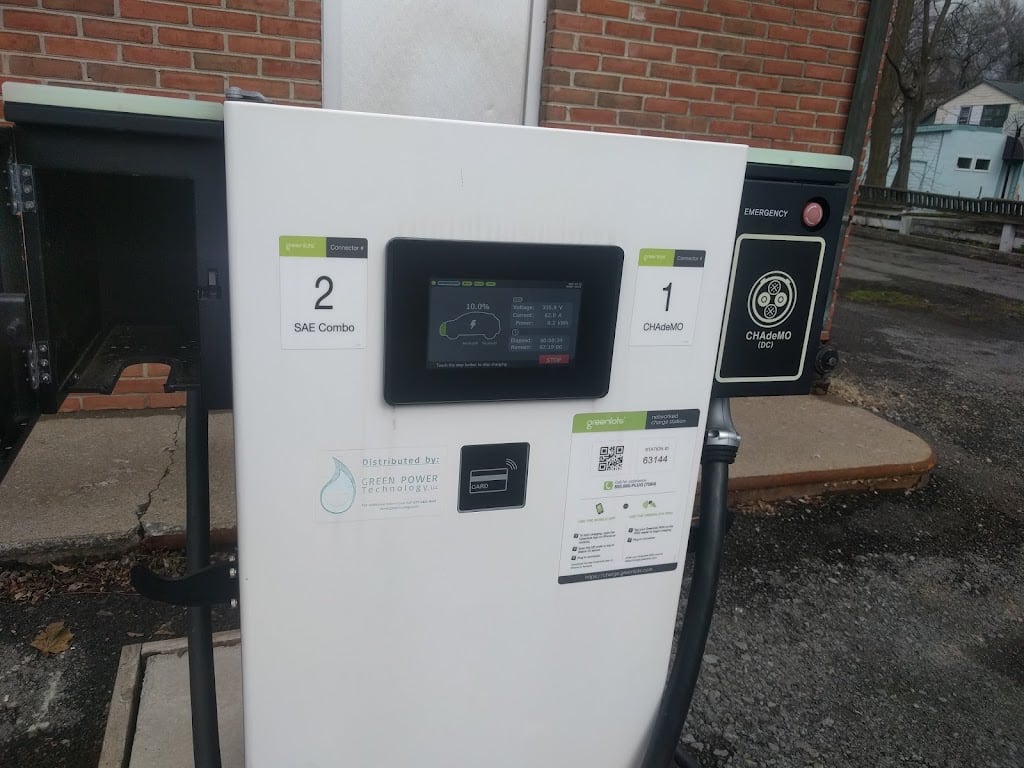 Charging station beside the brick shop wall