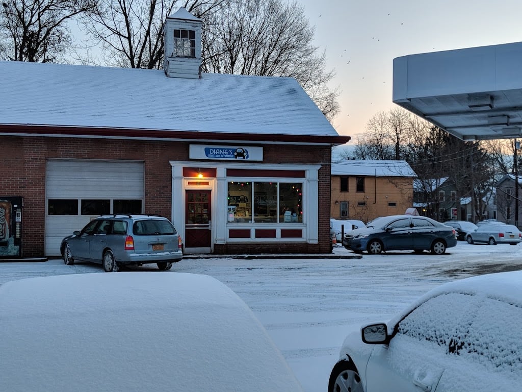 Diane's Downtown Automotive storefront on a snowy evening